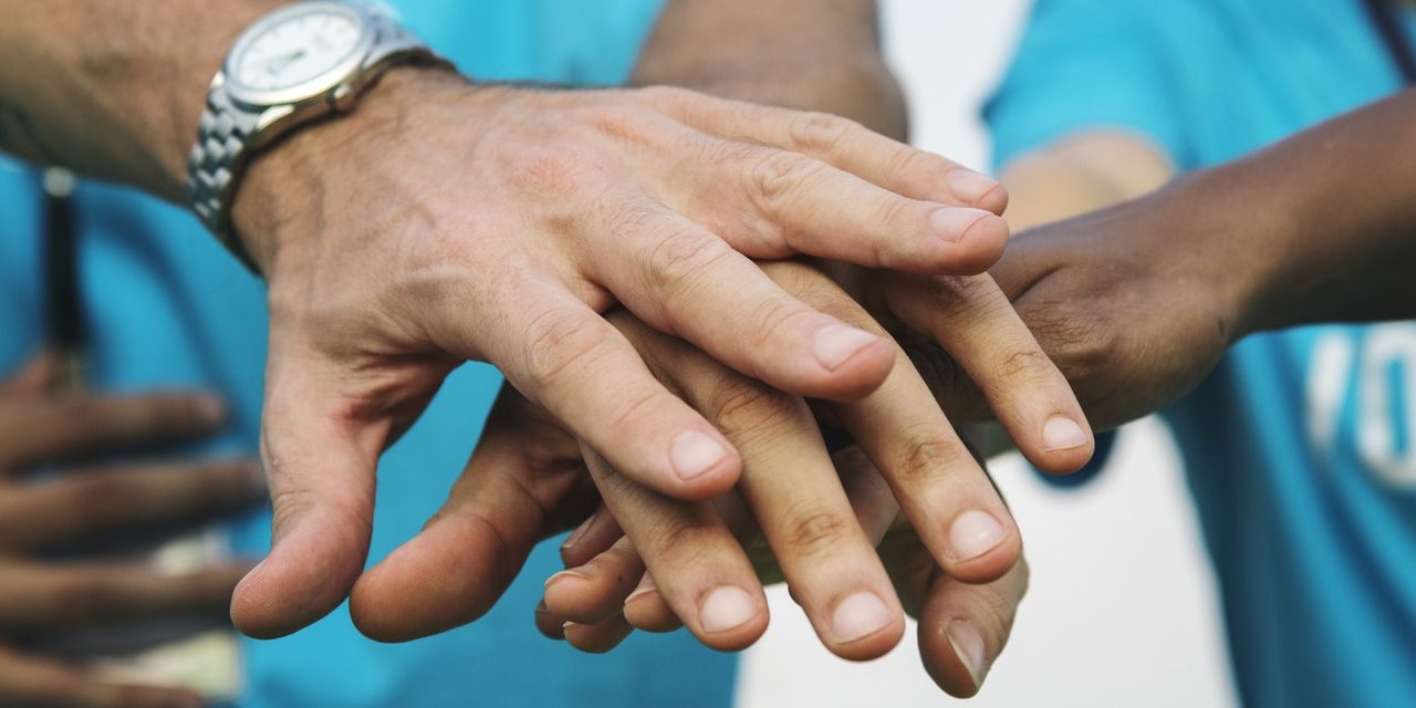 Hands-In-History Helping Hands Laying Over Each Other