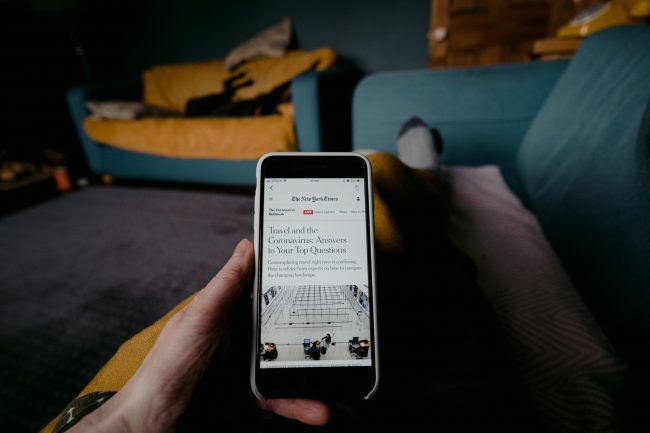 reading covid update on a smartphone