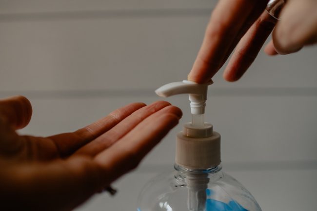 pumping sanitizer on hands