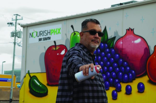 Lalo Cota in front of Mural at Nourish PHX