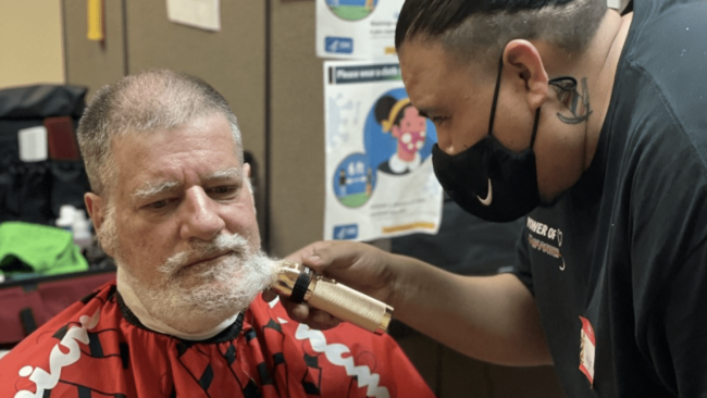 Man getting his beard shaved