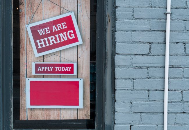 Now Hiring Sign Nourish Phx Now Hiring red sign reading apply today. Program Manager position.